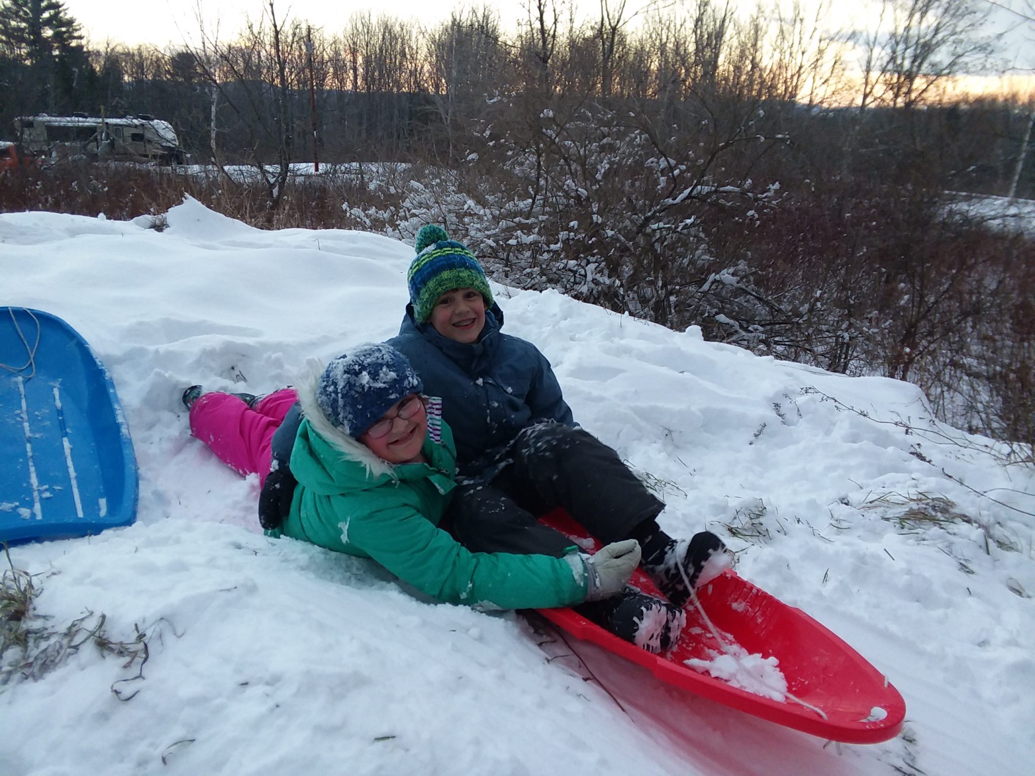 Sledding with kids is a great way to include fitness in your homeschool.
