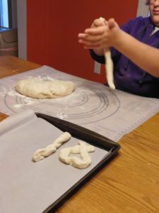 Kids shaping pretzel dough