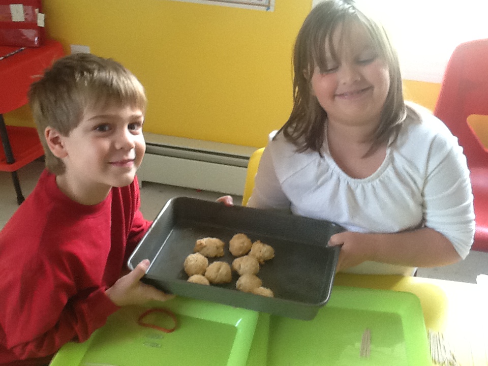 Kids showing the ancient biscuits they made. 
