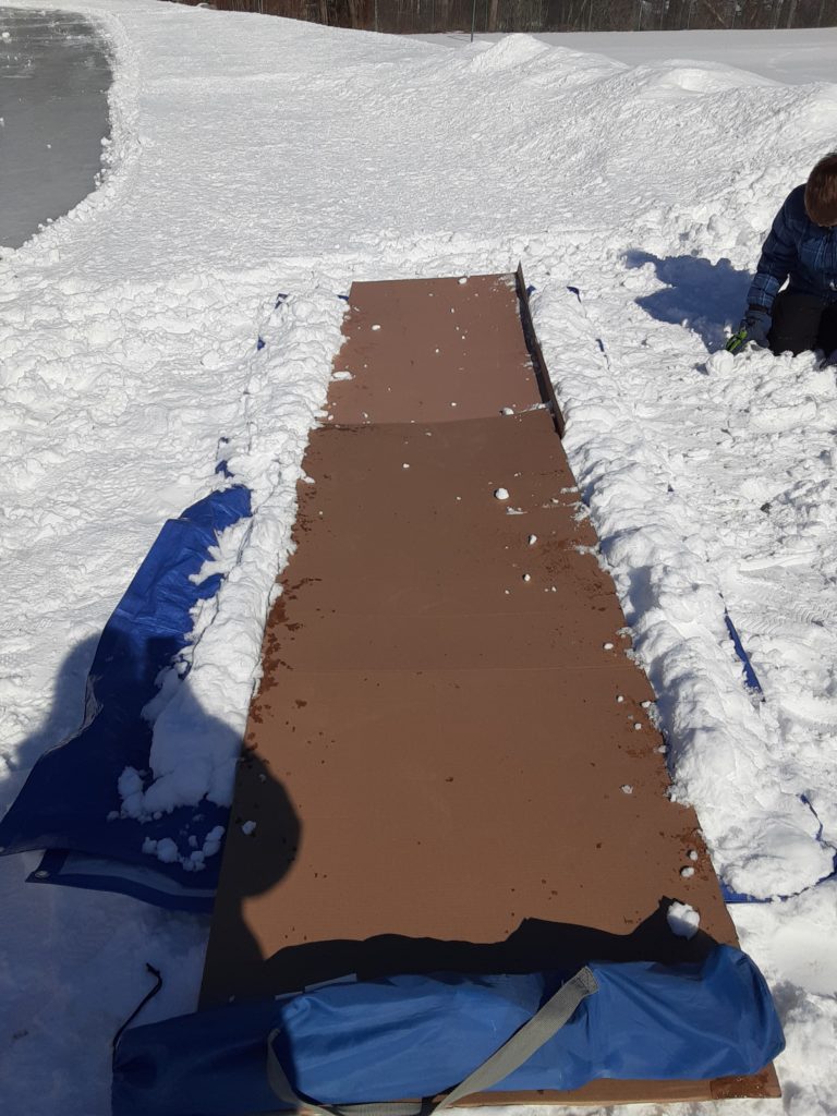 Cardboard bowling lane with snow bumpers for ice bowling winter activity