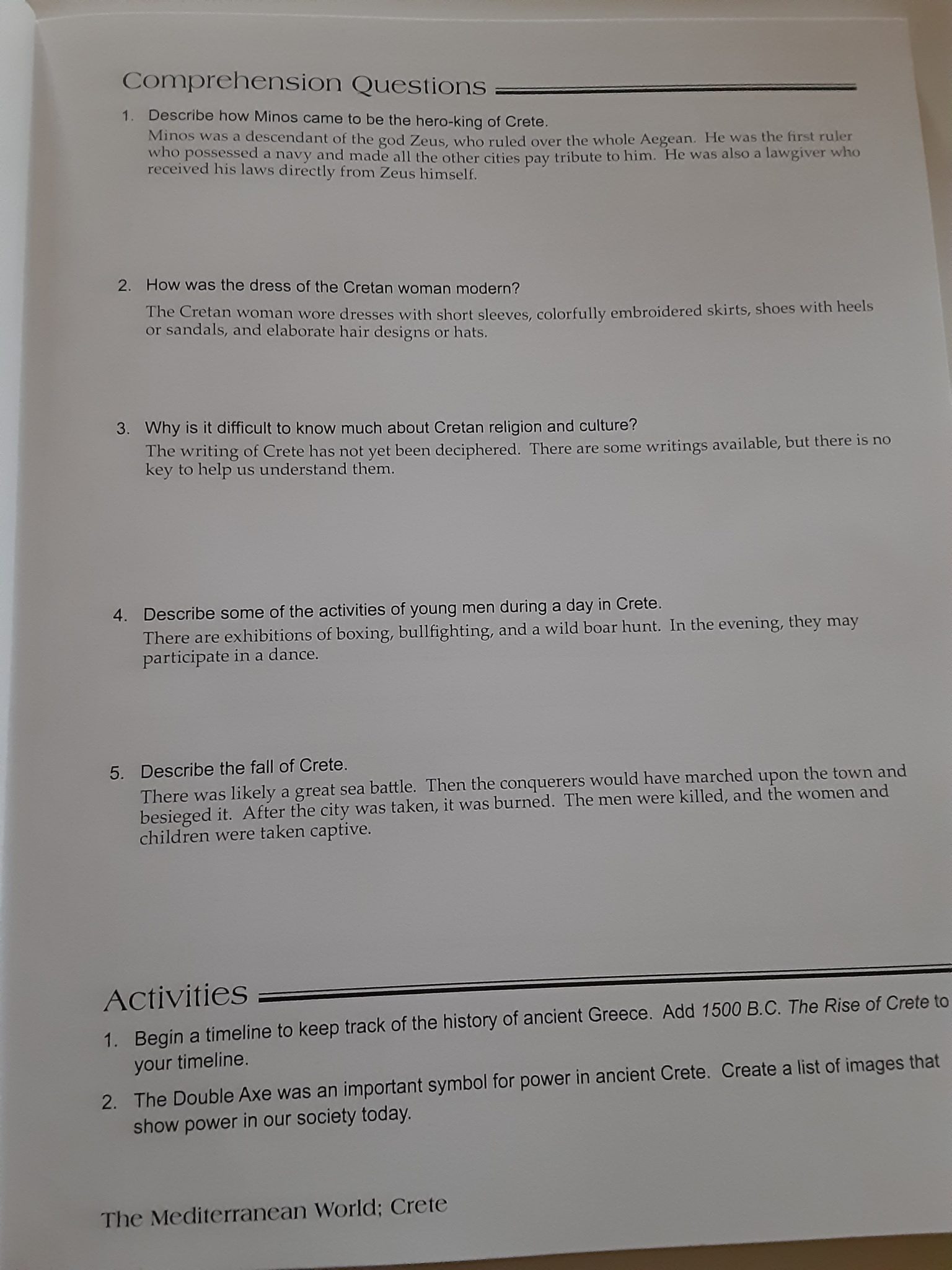 Sample page of teacher manual with answers filled in for comprehension questions.
