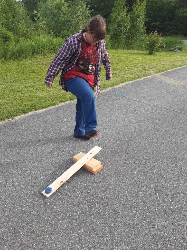 stomping on the catapult for this outdoor STEM activity