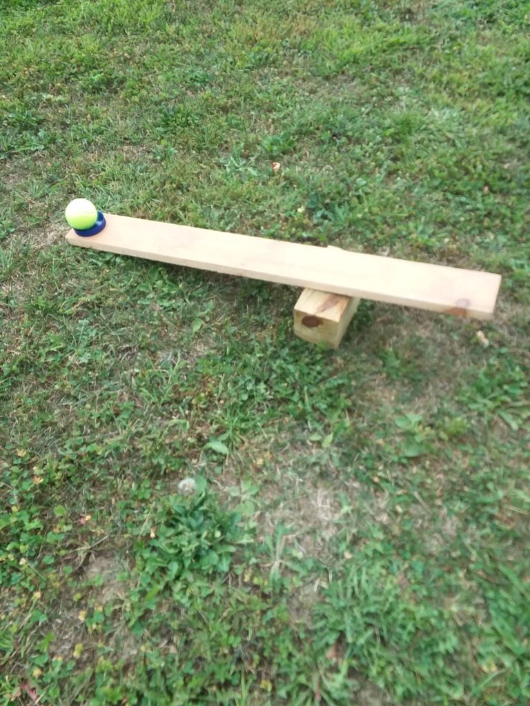 outdoor STEM Activity- catapult with cover glued on the end to hold a ball