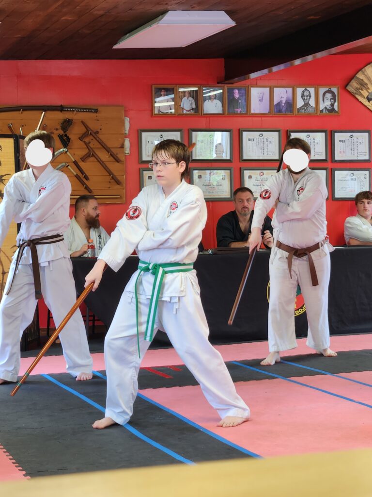 teen doing karate with a bo 