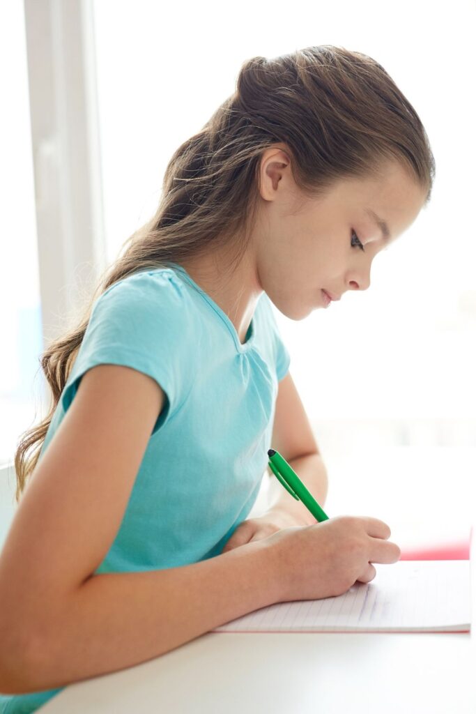 Girl writing; writing prompts add to Valentine's Day fun