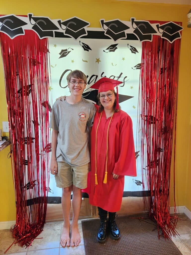 duaghter in cap and gown and son with her
