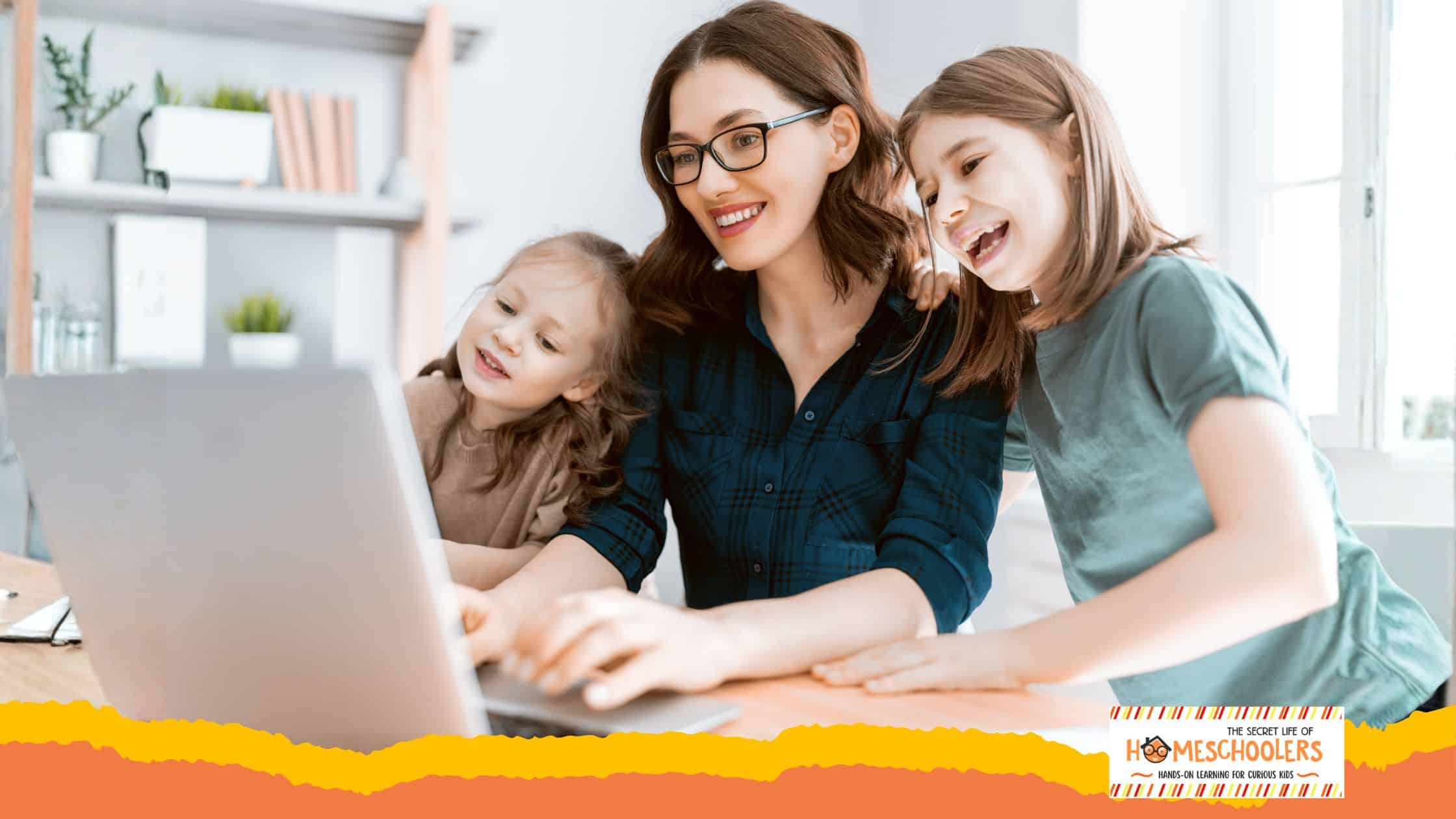 Mom looking at computer with kids